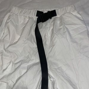 Windbreaker white pants with black buckle belt